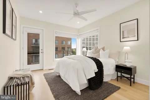 a bedroom with a bed and a painting on the wall