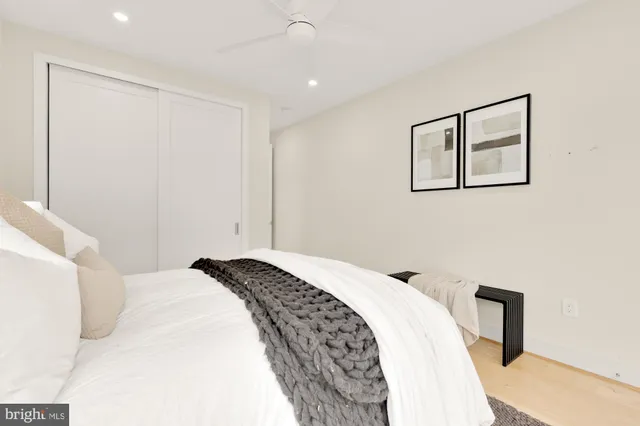 a bathroom with a granite countertop sink a toilet and bathtub