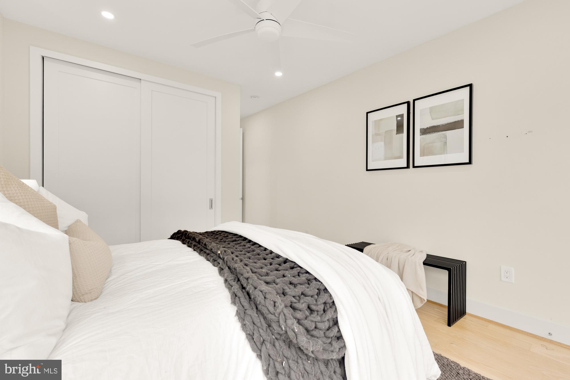 41 Q Street Northeast, Unit 2 Washington, DC 20002 - Photo 19 of 27 a bedroom with a bed and a painting on the wall