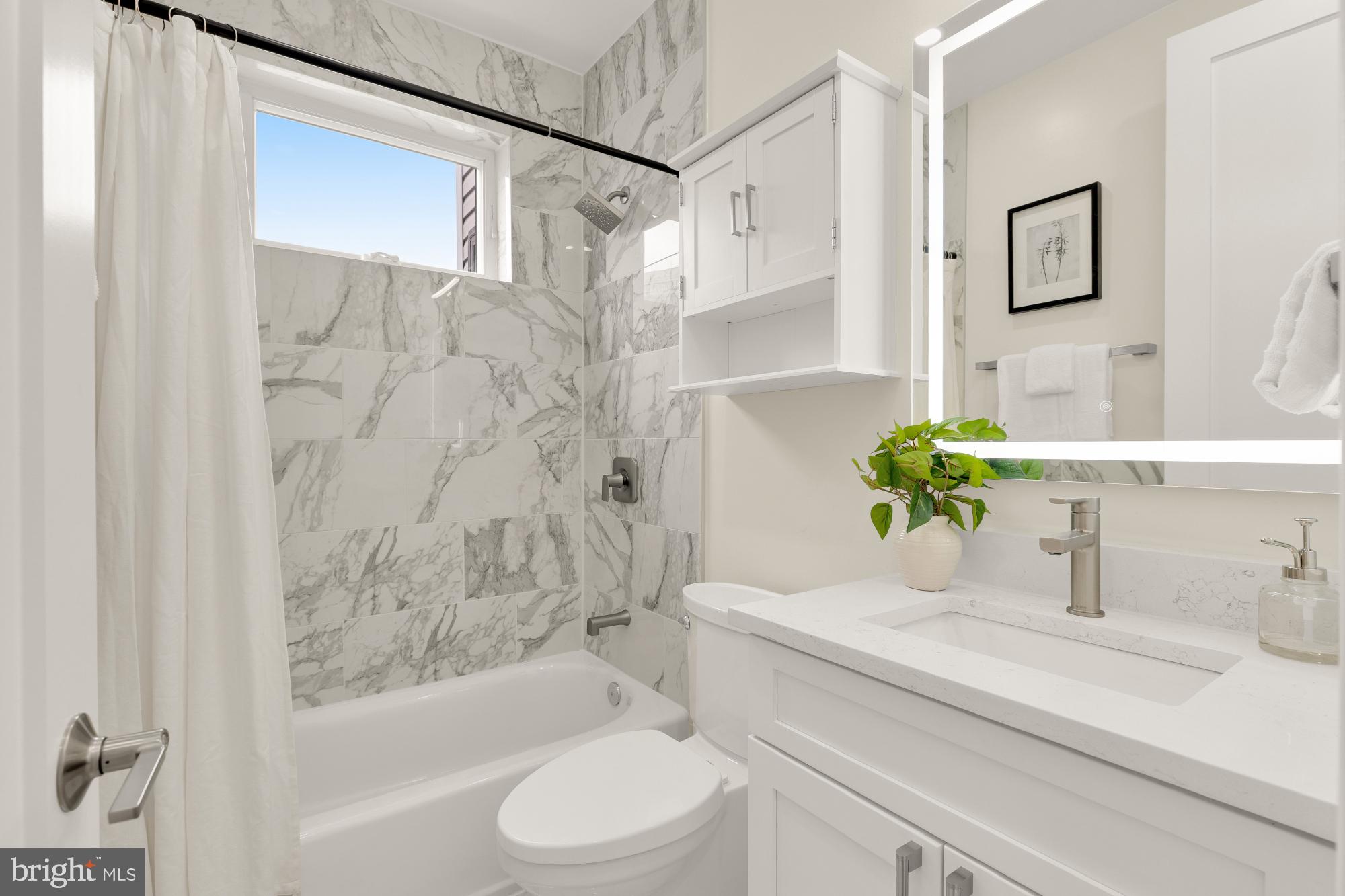 41 Q Street Northeast, Unit 2 Washington, DC 20002 - Photo 20 of 27 a bathroom with a granite countertop sink a toilet and bathtub