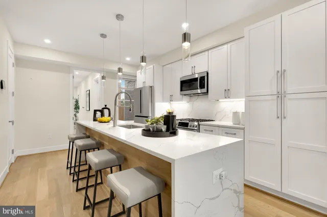 a kitchen with a sink cabinets and wooden floor