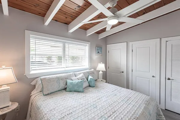 a bedroom with a large bed and a window