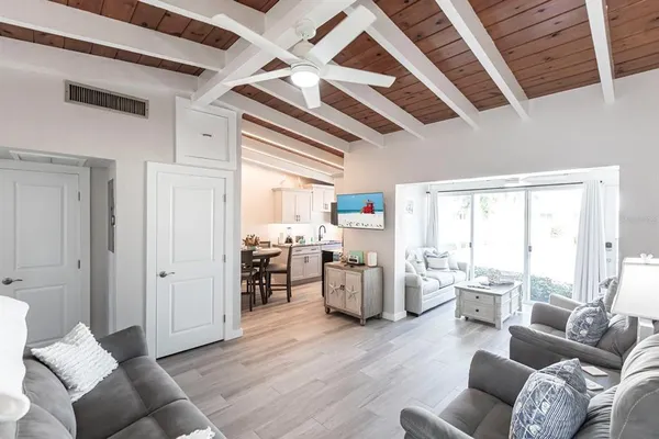 a living room with furniture window and wooden floor