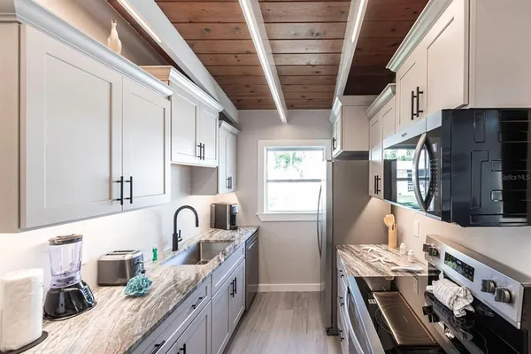 a kitchen with furniture and a wooden floors