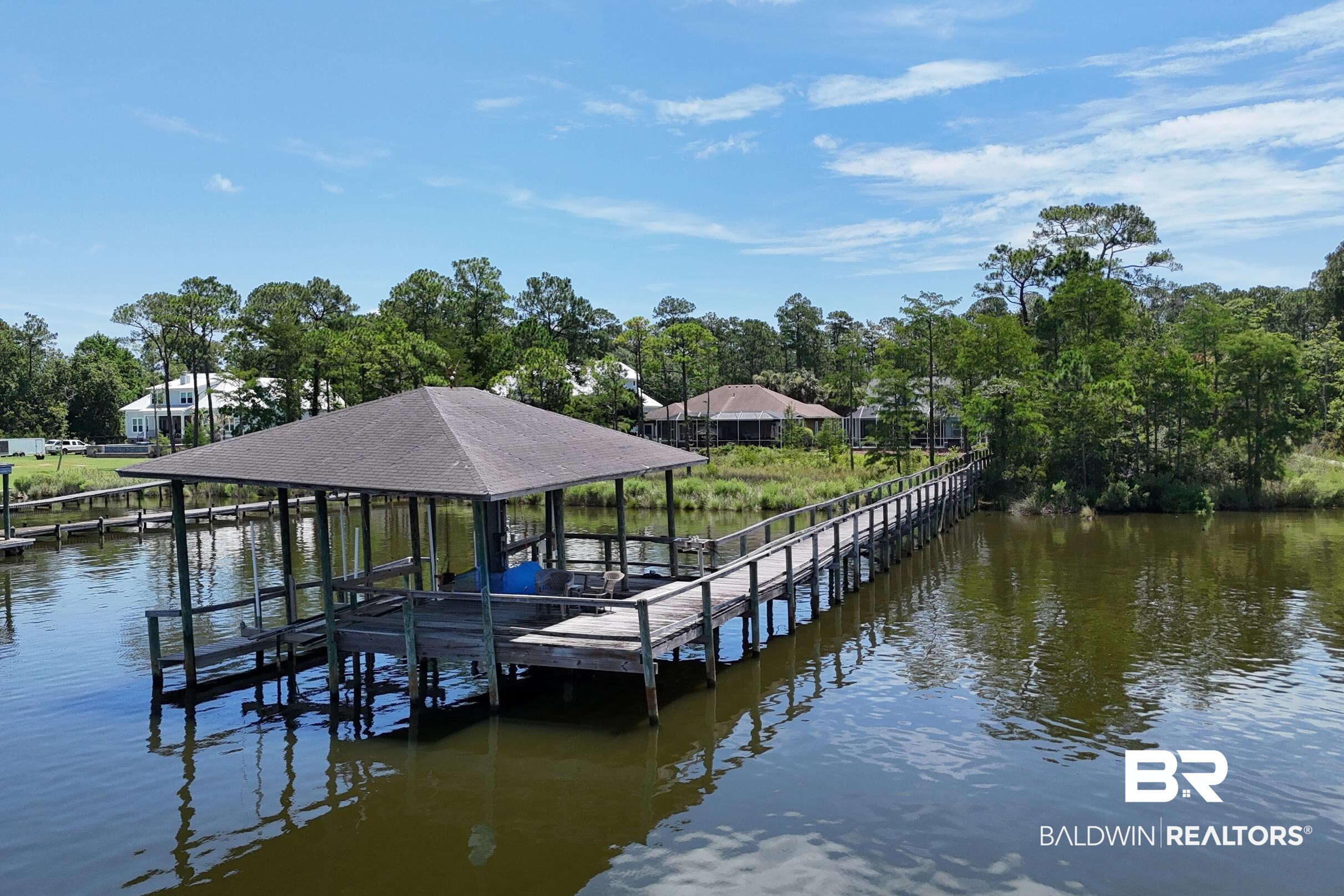 8585 Bay Harbor Road Elberta, AL 36530 - Photo 46 of 51 Dock with boat lift, a water view, and view of scattered trees