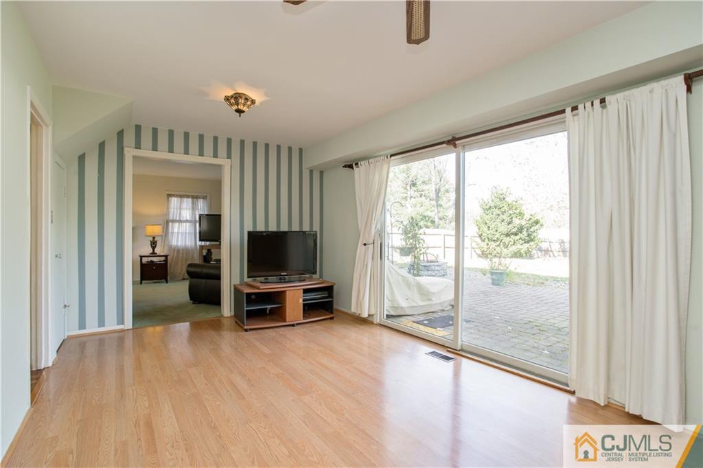 29 Abbott Road Somerset, NJ 08873 - Photo 3 of 10 a living room with furniture and a flat screen tv
