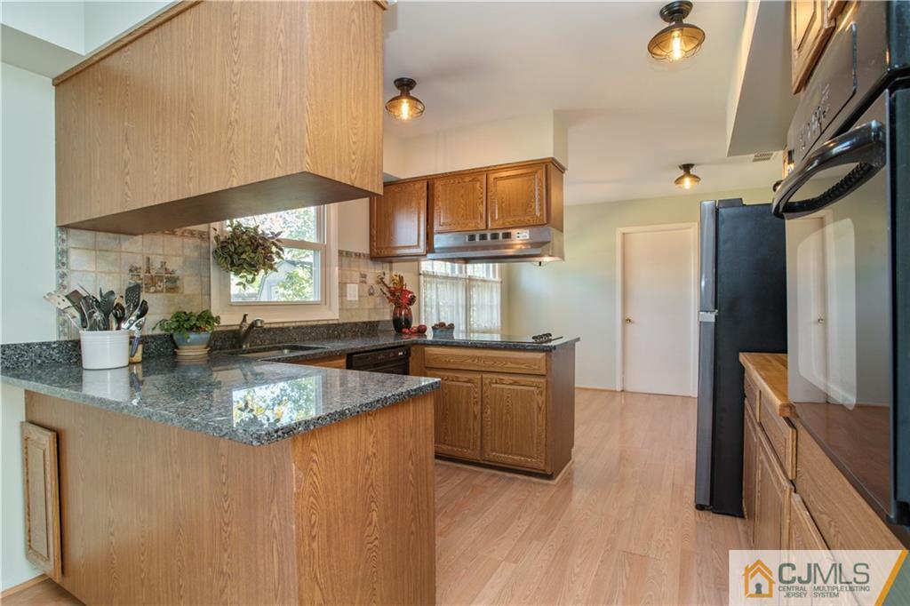 29 Abbott Road Somerset, NJ 08873 - Photo 4 of 10 a kitchen with stainless steel appliances granite countertop a sink a stove and a refrigerator