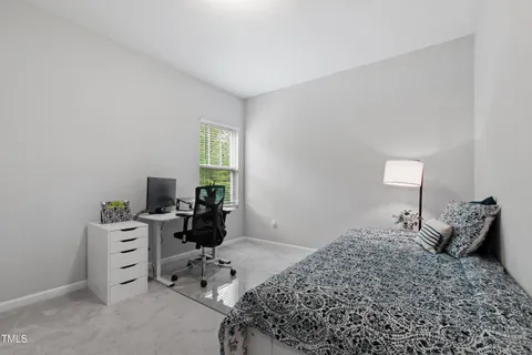 a living room with furniture and a baby crib