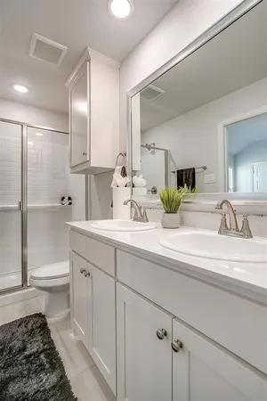 a bathroom with a double vanity sink and a mirror
