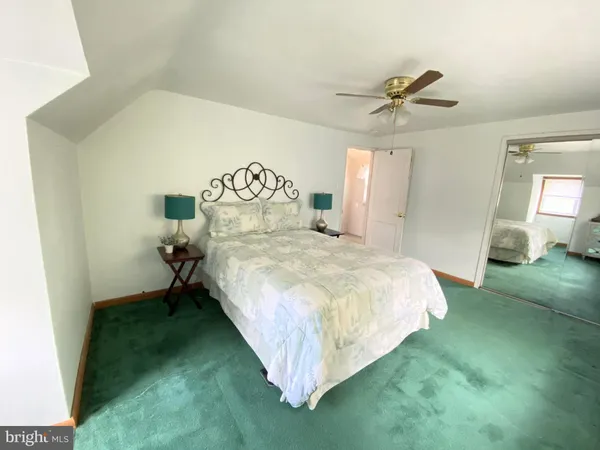a bed room with a bed and a chandelier