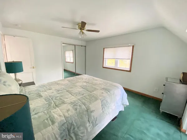 a spacious bedroom with a bed and a couch