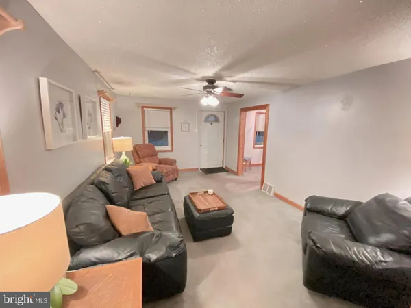 a living room with furniture or couch and a chandelier