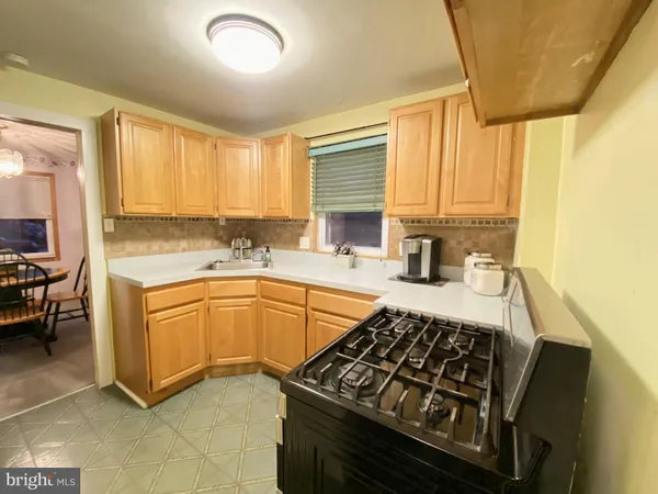 a kitchen with stainless steel appliances a sink stove and cabinets