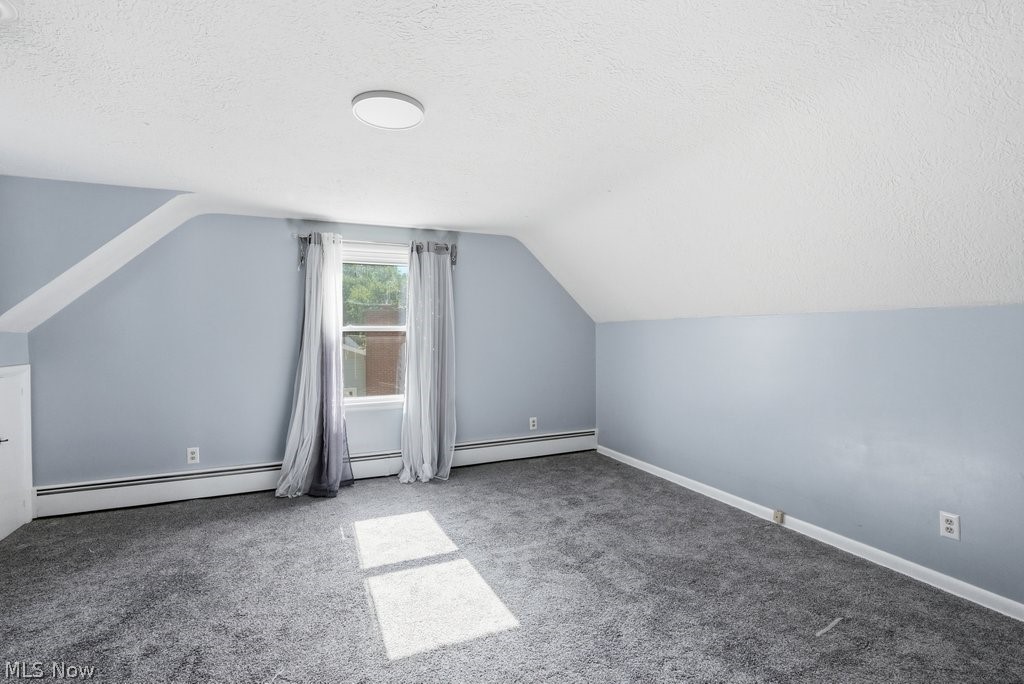 136 Pinehurst Road Munroe Falls, OH 44262 - Photo 25 of 48 Spacious room featuring gray carpeting, sloped ceilings, and a central window with draperies
