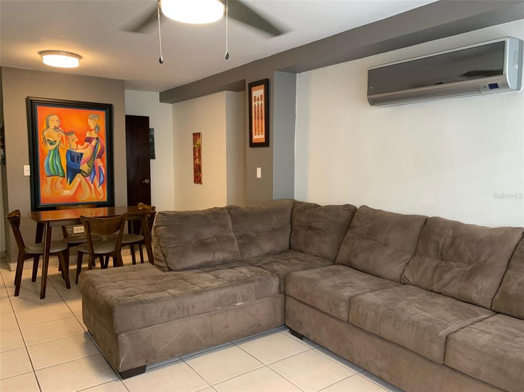 a living room with furniture and a flat screen tv