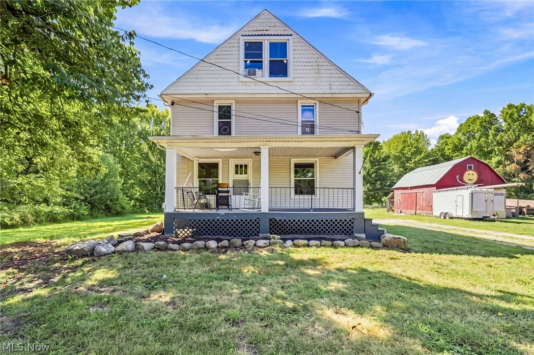 Two-story residence with a covered front porch and white vertical columns