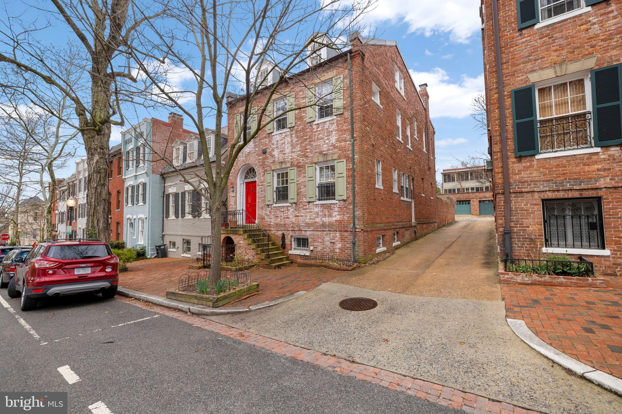 a cars parked in front of brick building