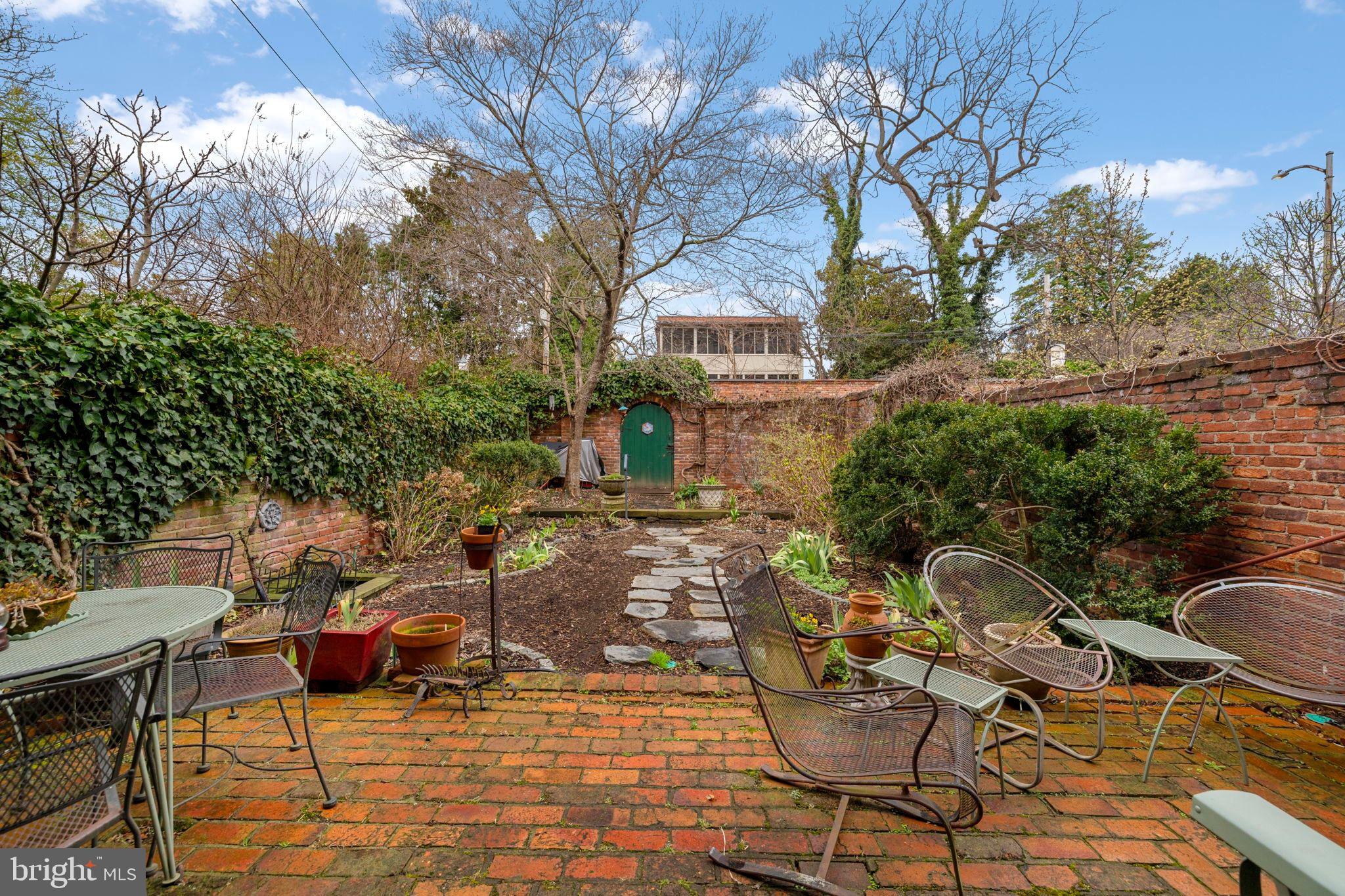 1554 34th Street Northwest Washington, DC 20007 - Photo 11 of 15 a view of a patio with table and chairs and potted plants