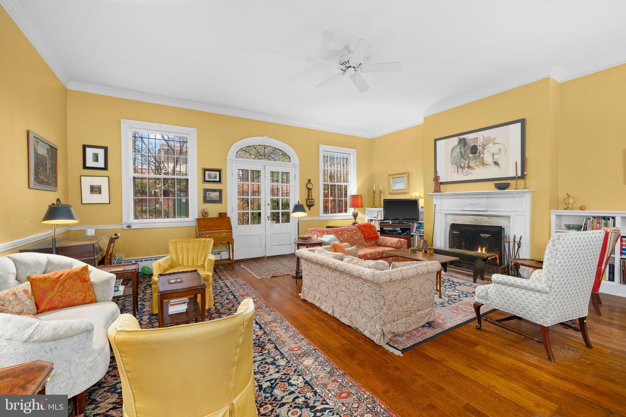 1554 34th Street Northwest Washington, DC 20007 - Photo 5 of 15 a living room with furniture a fireplace and a large window