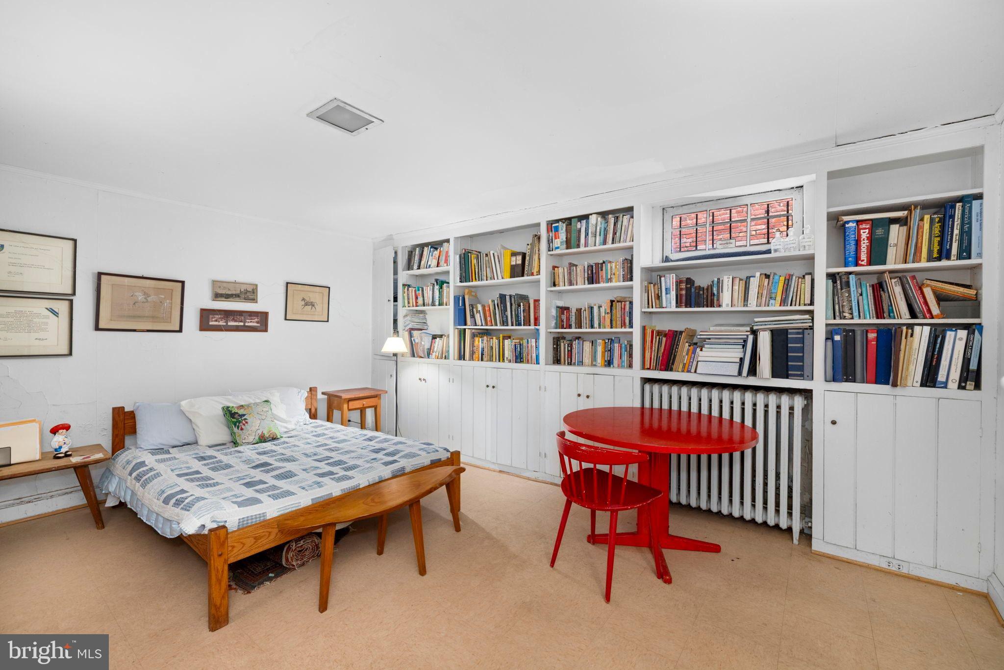 1554 34th Street Northwest Washington, DC 20007 - Photo 6 of 15 a living room with lots of furniture and a book shelf