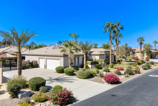 a view of a patio with table and chairs and potted plants