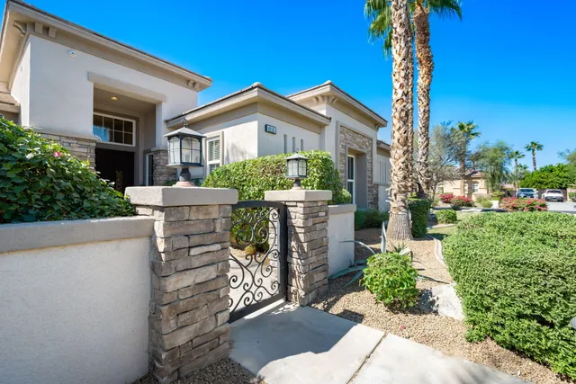 a view of a backyard with plants and outdoor seating