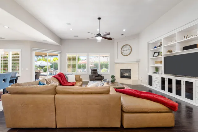 a large white kitchen with a large window a sink a counter space and stainless steel appliances