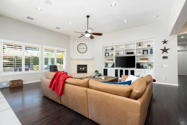 a kitchen with a stove a refrigerator a sink and dishwasher with wooden floor