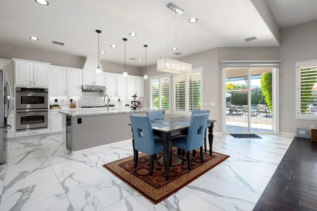 a view of a patio with a table and chairs