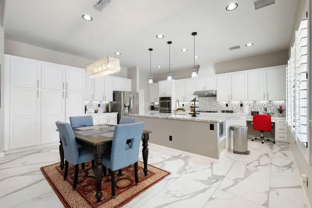 a view of a patio with couches and table under an umbrella