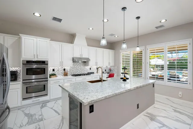 a bedroom with a bed a flat screen tv and a couch