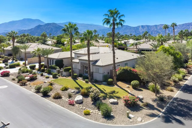 an aerial view of multiple houses with a yard