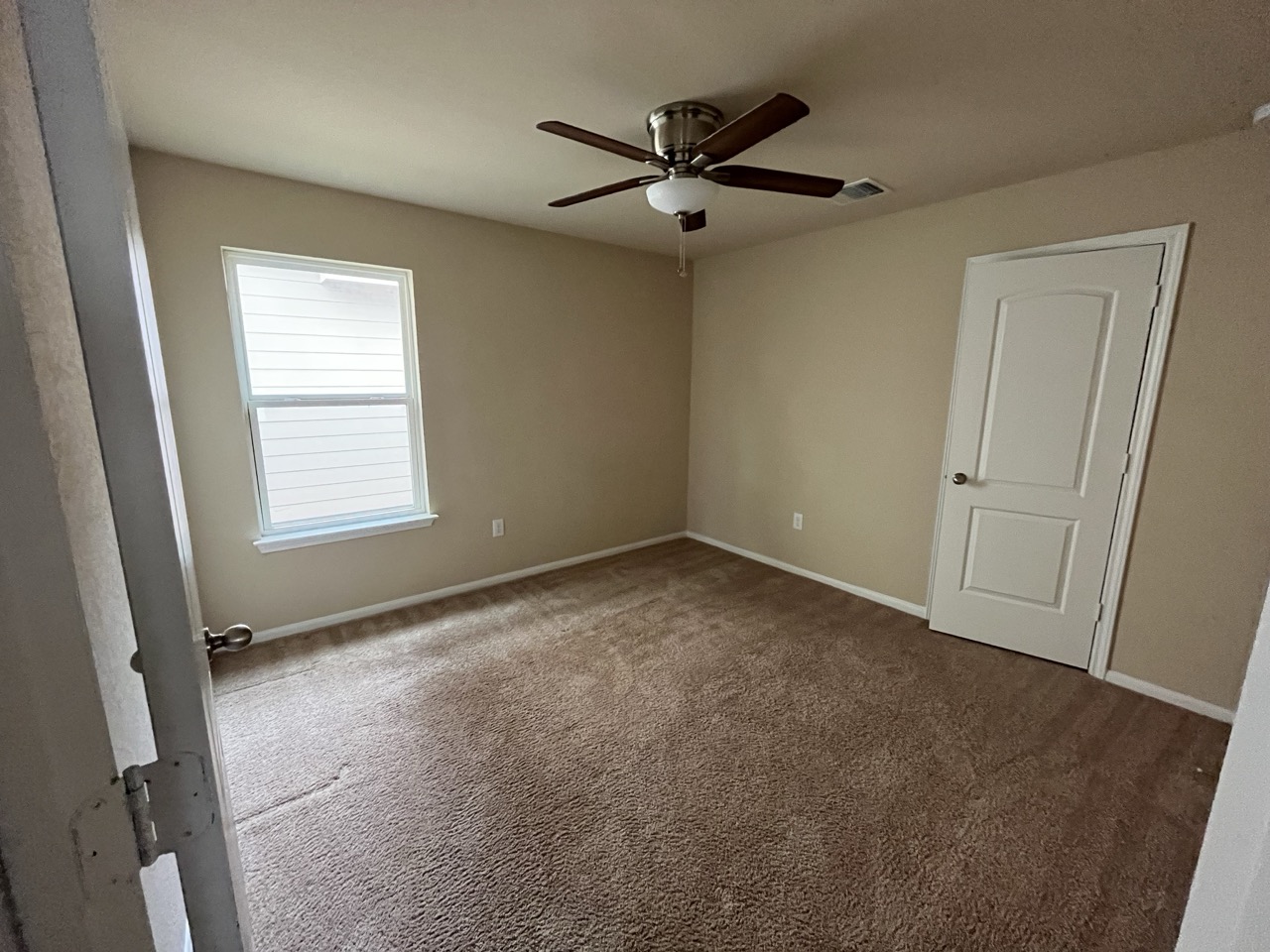 3510 Wickham Lane Austin, TX 78725 - Photo 10 of 16 Spare room featuring dark colored carpet and a ceiling fan