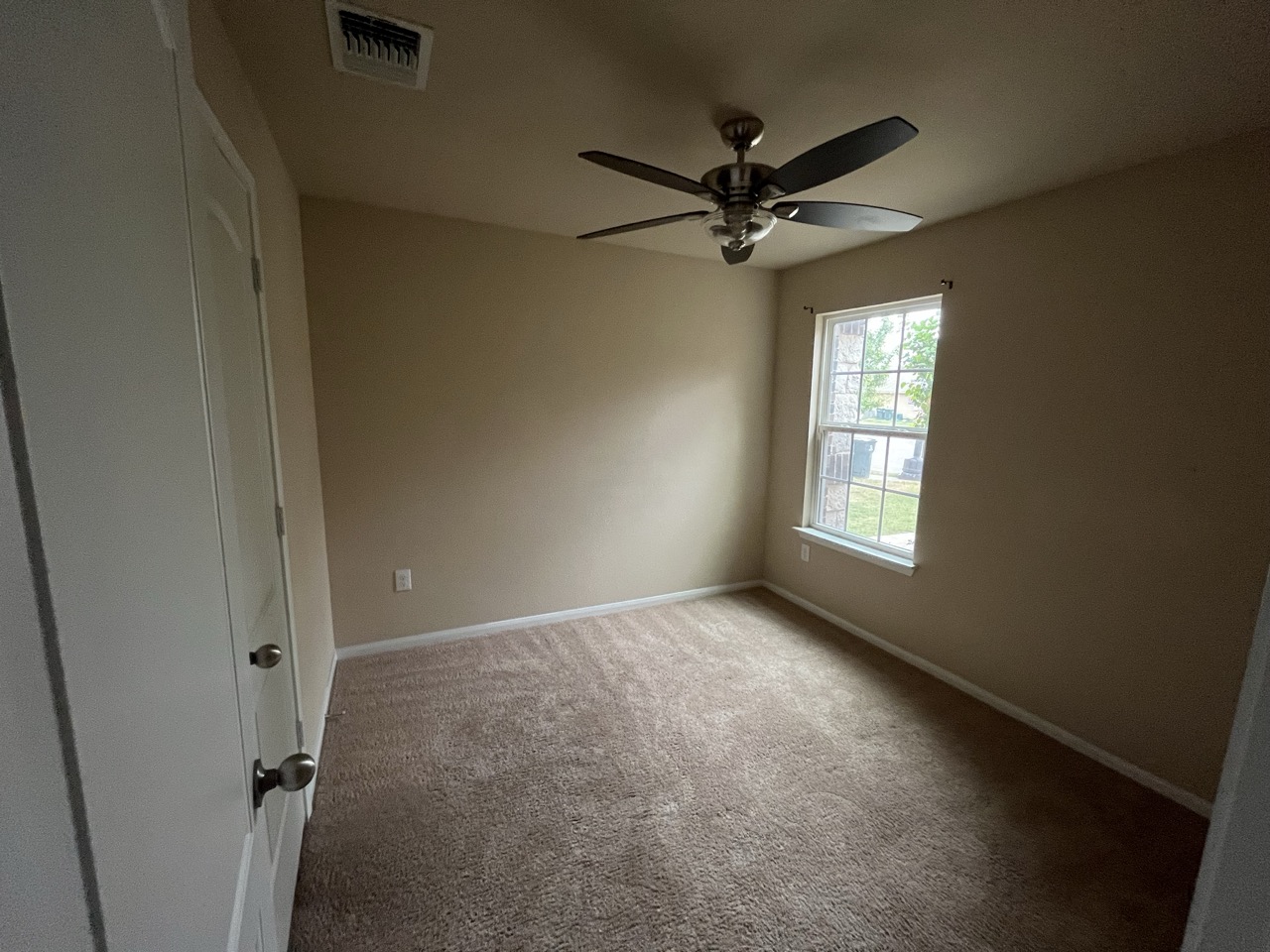 3510 Wickham Lane Austin, TX 78725 - Photo 11 of 16 Unfurnished bedroom with light colored carpet and ceiling fan