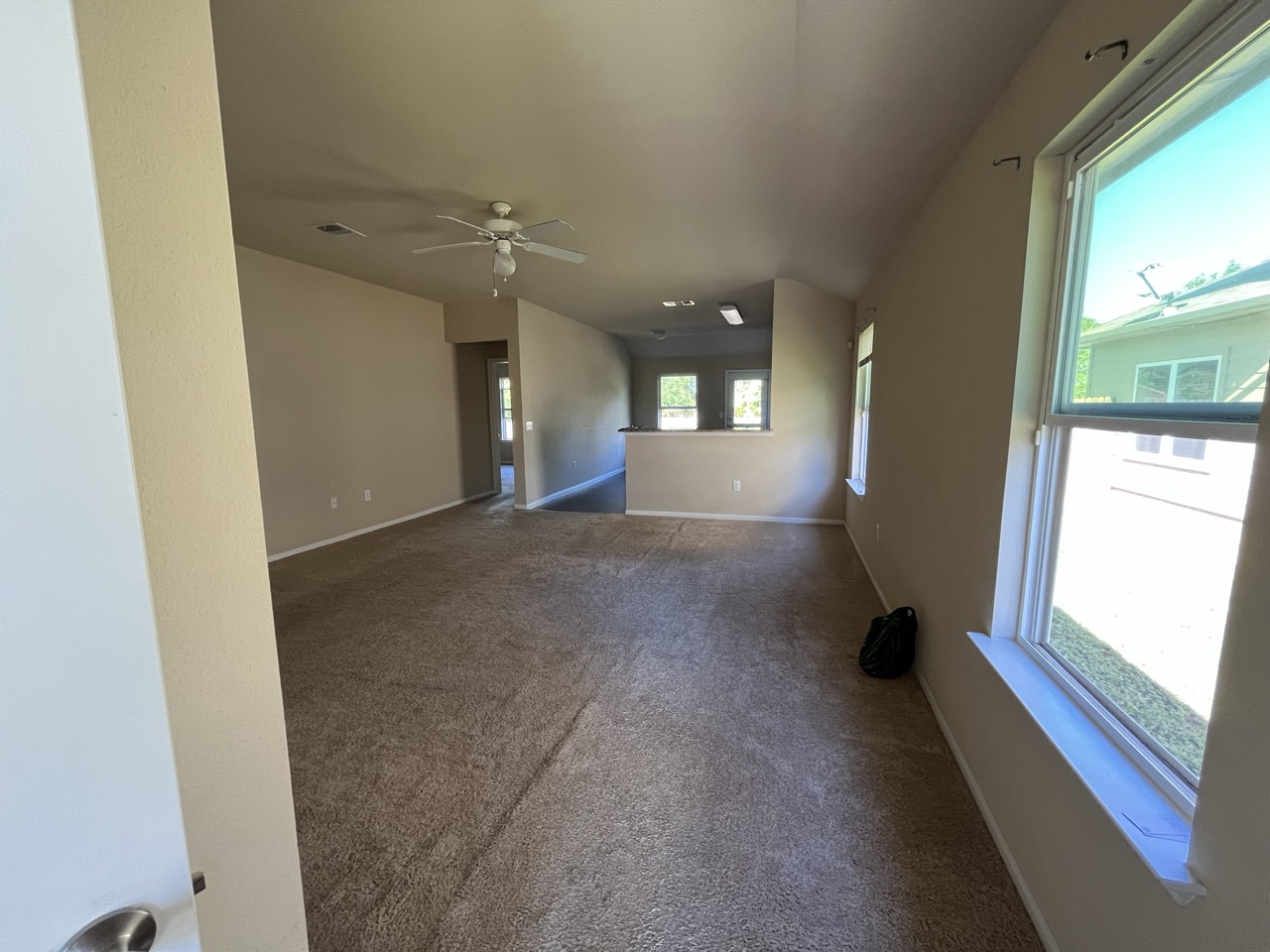 3510 Wickham Lane Austin, TX 78725 - Photo 5 of 16 Empty room with dark colored carpet and a ceiling fan