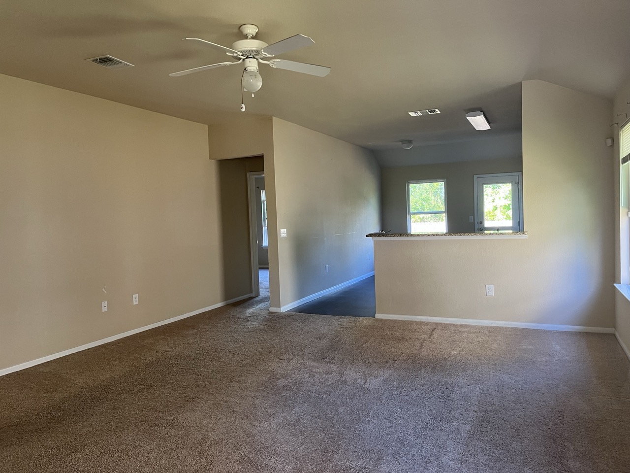 3510 Wickham Lane Austin, TX 78725 - Photo 6 of 16 Unfurnished room featuring dark colored carpet and a ceiling fan