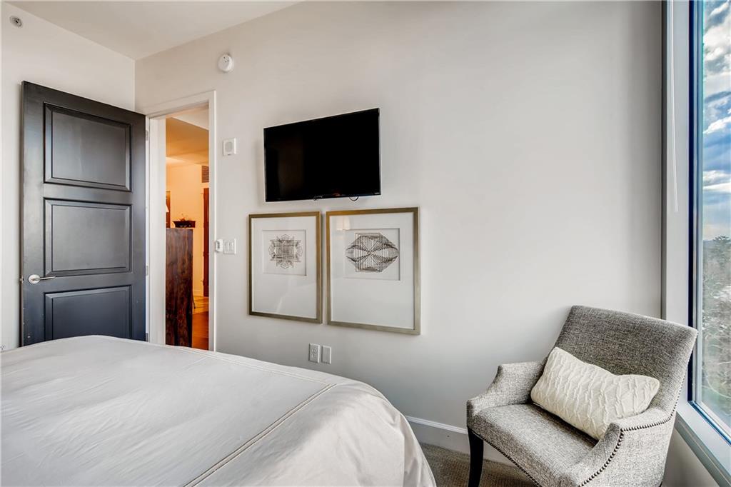 1820 Peachtree Road Northwest, Unit 811 Atlanta, GA 30309 - Photo 15 of 42 a bedroom with a bed and a flat screen tv