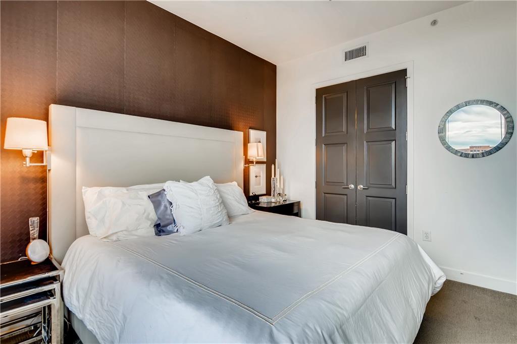 1820 Peachtree Road Northwest, Unit 811 Atlanta, GA 30309 - Photo 16 of 42 a bedroom with a large bed and a closet