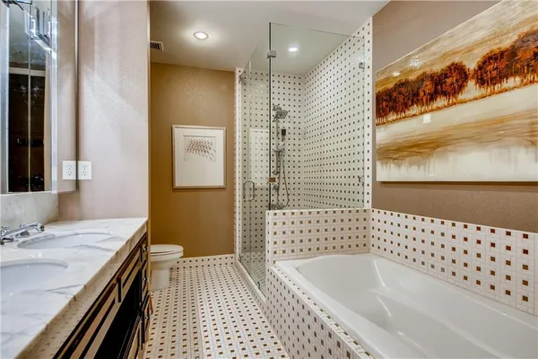a bathroom with a bathtub sink and mirror