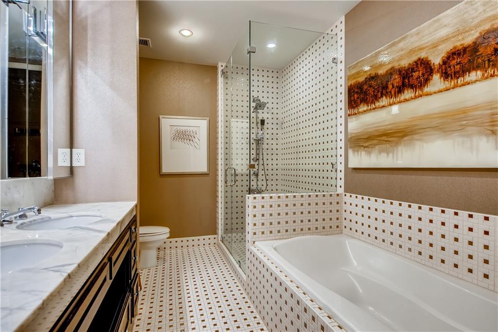 1820 Peachtree Road Northwest, Unit 811 Atlanta, GA 30309 - Photo 17 of 42 a bathroom with a bathtub sink and mirror