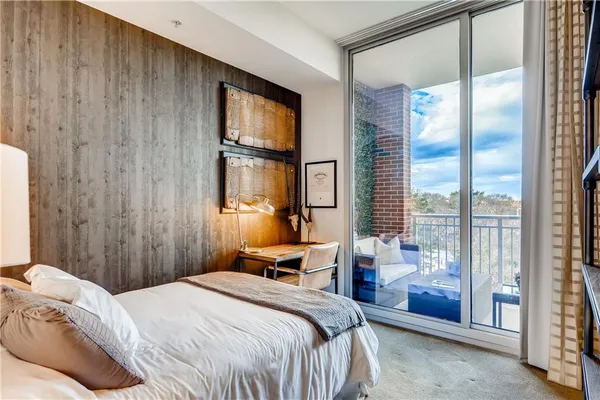 a bedroom with a bed and a large window