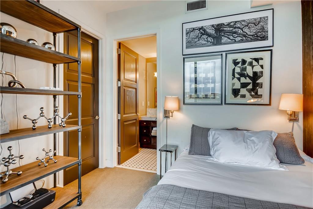 1820 Peachtree Road Northwest, Unit 811 Atlanta, GA 30309 - Photo 20 of 42 a bedroom with a large bed and a window with chair