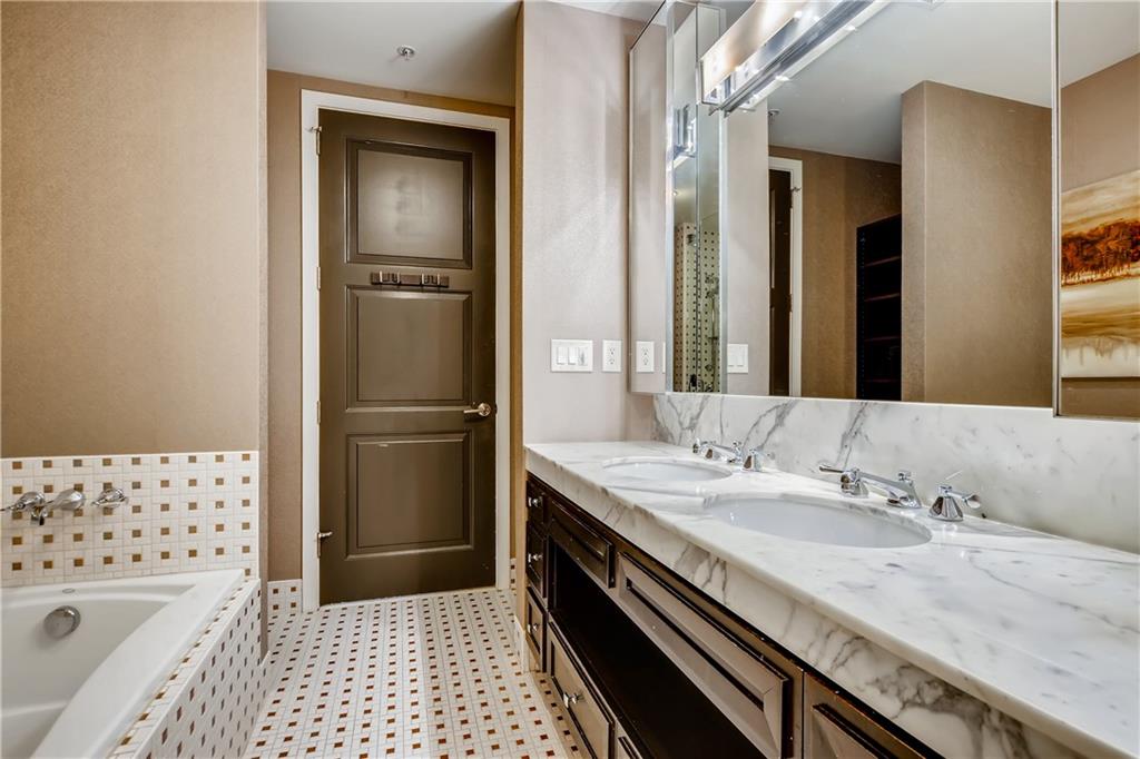 1820 Peachtree Road Northwest, Unit 811 Atlanta, GA 30309 - Photo 33 of 42 a bathroom with a granite countertop sink a toilet and shower