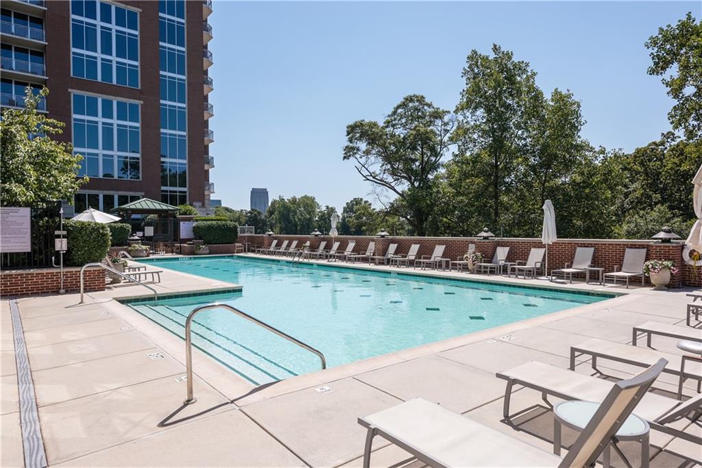 1820 Peachtree Road Northwest, Unit 811 Atlanta, GA 30309 - Photo 38 of 42 a view of a swimming pool with a lounge chairs