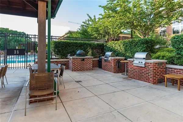 a view of a patio with a chairs and potted plants