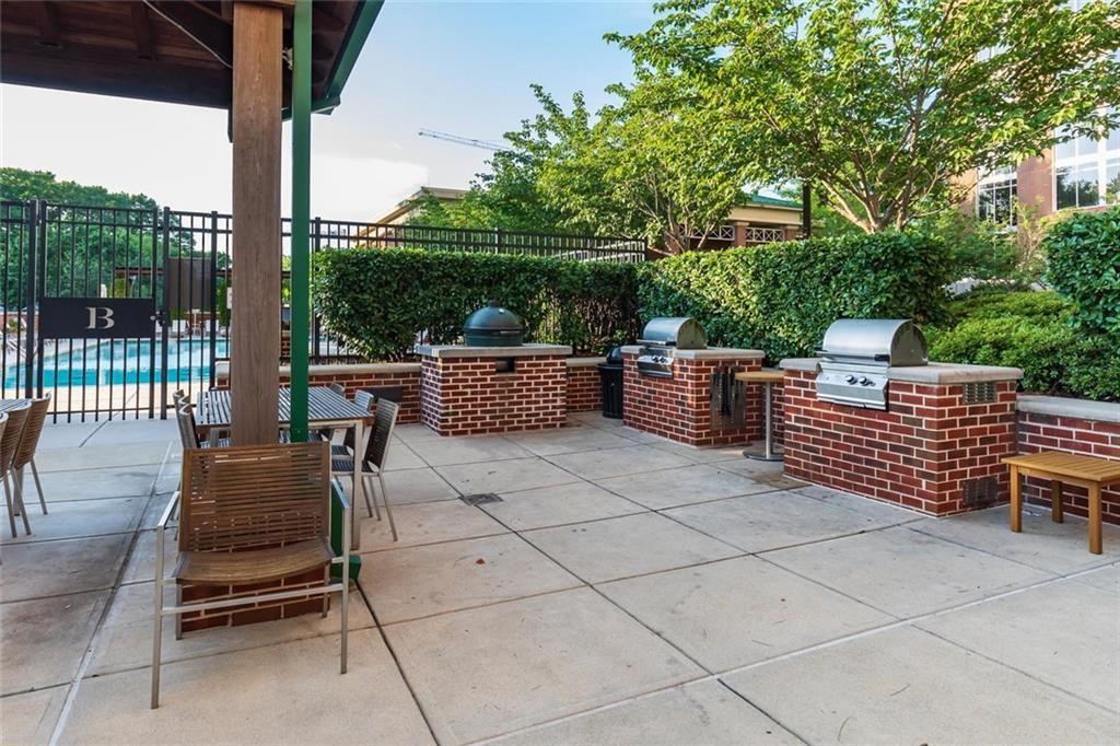 1820 Peachtree Road Northwest, Unit 811 Atlanta, GA 30309 - Photo 40 of 42 a view of a patio with a chairs and potted plants