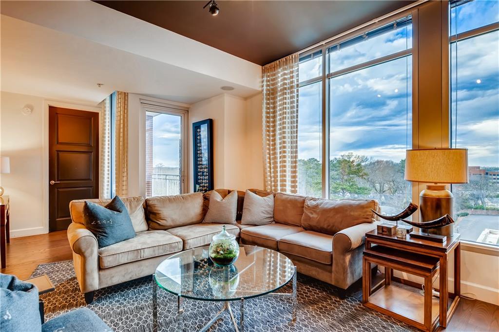 1820 Peachtree Road Northwest, Unit 811 Atlanta, GA 30309 - Photo 4 of 42 a living room with furniture and a large window