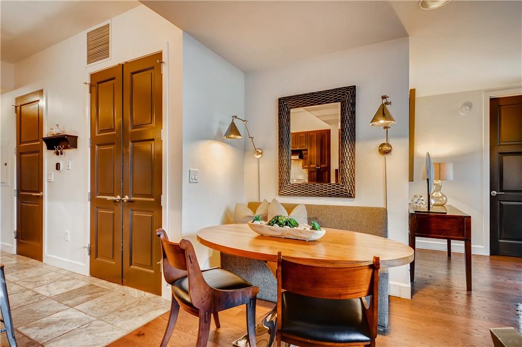 1820 Peachtree Road Northwest, Unit 811 Atlanta, GA 30309 - Photo 6 of 42 a dining room with furniture and wooden floor