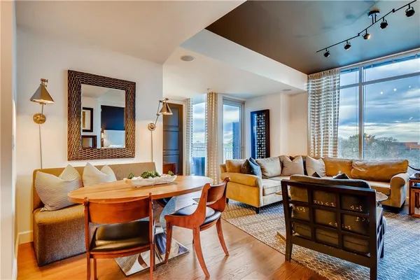 a living room with furniture and floor to ceiling windows