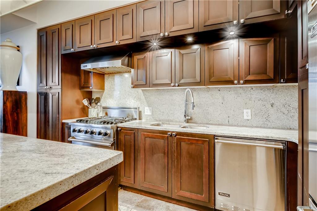 1820 Peachtree Road Northwest, Unit 811 Atlanta, GA 30309 - Photo 9 of 42 a kitchen with stainless steel appliances granite countertop a sink stove and refrigerator